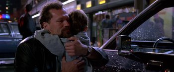 Movie still from “The Replacement Killers” (1998), directed by Antoine Fuqua – A man holding a child in his arms; Close Up shot, Low angle
