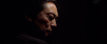 Movie still from “The Replacement Killers” (1998), directed by Antoine Fuqua – A person wearing a black jacket; Close Up shot, Low angle