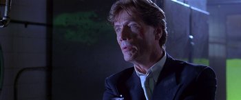 Movie still from “The Replacement Killers” (1998), directed by Antoine Fuqua – A person wearing a suit and tie; Close Up shot, Low angle