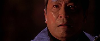 Movie still from “The Replacement Killers” (1998), directed by Antoine Fuqua – A man's face with tears coming out of his eyes; Close Up shot, Low angle