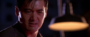 Movie still from “The Replacement Killers” (1998), directed by Antoine Fuqua – A man's face in a dimly - lit room; Close Up shot, Low angle