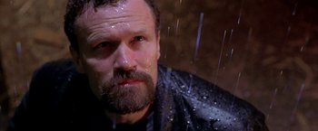 Movie still from “The Replacement Killers” (1998), directed by Antoine Fuqua – A man with a beard and a wet shirt; Close Up shot, Low angle