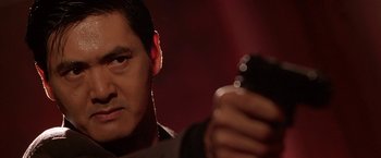 Movie still from “The Replacement Killers” (1998), directed by Antoine Fuqua – A person holding a cell phone; Close Up shot, Low angle