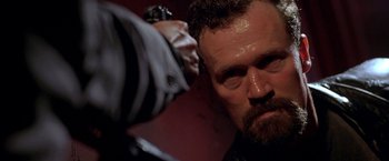 Movie still from “The Replacement Killers” (1998), directed by Antoine Fuqua – A man's face as he combs another man's hair; Close Up shot, Low angle