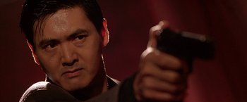 Movie still from “The Replacement Killers” (1998), directed by Antoine Fuqua – A person taking a picture with a cell phone; Close Up shot, Low angle