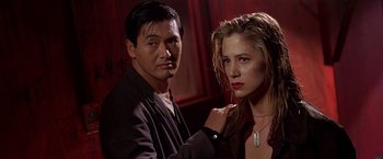 Movie still from “The Replacement Killers” (1998), directed by Antoine Fuqua – A man and a woman posing for a picture; Close Up shot, Low angle