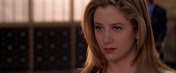 Movie still from “The Replacement Killers” (1998), directed by Antoine Fuqua – A person with long hair; Close Up shot, Over the shoulder angle