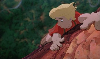 Movie still from “The Rescuers Down Under” (1990), directed by Mike Gabriel – A young blond haired boy looking over a tree trunk; Medium shot, Overhead angle