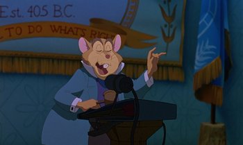 Movie still from “The Rescuers Down Under” (1990), directed by Mike Gabriel – A cartoon of a mouse holding a microphone and speaking; Medium shot, High angle