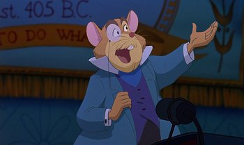 Movie still from “The Rescuers Down Under” (1990), directed by Mike Gabriel – A cartoon of a mouse wearing a blue suit and holding a microphone in his hand; Close Up shot, Low angle
