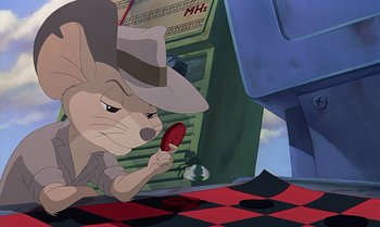 Movie still from “The Rescuers Down Under” (1990), directed by Mike Gabriel – A mouse in a hat is holding a red object; Close Up shot, Over the shoulder angle