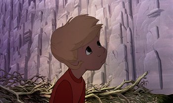 Movie still from “The Rescuers Down Under” (1990), directed by Mike Gabriel – A cartoon picture of a young boy in front of a cliff; Medium shot, Low angle