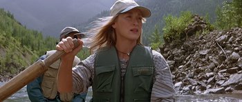 Movie still from “The River Wild” (1994), directed by Curtis Hanson – A woman wearing a hat and a green vest; Medium shot, Low angle