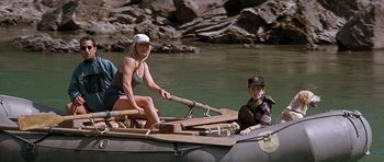 Movie still from “The River Wild” (1994), directed by Curtis Hanson – A woman and a boy in a boat on a river; Wide shot, High angle