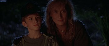Movie still from “The River Wild” (1994), directed by Curtis Hanson – A woman and a young boy are posing for a picture; Close Up shot, Over the shoulder angle