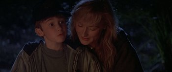 Movie still from “The River Wild” (1994), directed by Curtis Hanson – A woman and a boy looking at the camera; Close Up shot, Over the shoulder angle