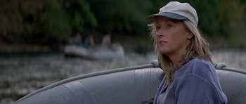 Movie still from “The River Wild” (1994), directed by Curtis Hanson – A woman sitting in a boat on a river; Close Up shot, Over the shoulder angle