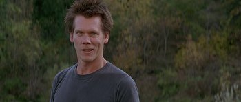 Movie still from “The River Wild” (1994), directed by Curtis Hanson – A person smiling for the camera; Close Up shot, Low angle