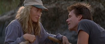 Movie still from “The River Wild” (1994), directed by Curtis Hanson – A man and a woman talking to each other outside; Close Up shot, Over the shoulder angle