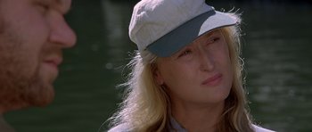 Movie still from “The River Wild” (1994), directed by Curtis Hanson – A person wearing a hat; Close Up shot, Over the shoulder angle