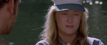 Movie still from “The River Wild” (1994), directed by Curtis Hanson – A person wearing a hat; Close Up shot, Over the shoulder angle
