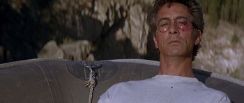 Movie still from “The River Wild” (1994), directed by Curtis Hanson – A man sitting in a chair with his eyes closed; Close Up shot, Low angle