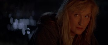 Movie still from “The River Wild” (1994), directed by Curtis Hanson – A person with long blonde hair; Close Up shot, Over the shoulder angle