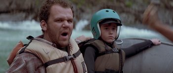 Movie still from “The River Wild” (1994), directed by Curtis Hanson – A man and a boy wearing a helmet and life jackets; Close Up shot, Low angle