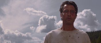 Movie still from “The River Wild” (1994), directed by Curtis Hanson – A person wearing glasses and a white shirt; Close Up shot, Low angle
