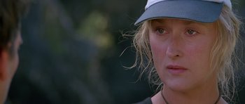 Movie still from “The River Wild” (1994), directed by Curtis Hanson – A person wearing a hat; Close Up shot, Over the shoulder angle