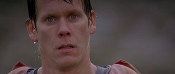 Movie still from “The River Wild” (1994), directed by Curtis Hanson – A man's face as he stares into the distance; Close Up shot, Over the shoulder angle