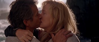 Movie still from “The River Wild” (1994), directed by Curtis Hanson – A man and a woman kissing each other; Close Up shot, Low angle