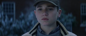 Movie still from “The Rookie” (2002), directed by John Lee Hancock – A young man wearing a hat and a jacket; Close Up shot, High angle