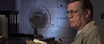 Movie still from “The Rookie” (2002), directed by John Lee Hancock – An older man wearing glasses looking at a fan; Close Up shot, Low angle
