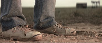 Movie still from “The Rookie” (2002), directed by John Lee Hancock – A person's feet in a pair of shoes; Close Up shot, Low angle