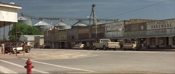 Movie still from “The Rookie” (2002), directed by John Lee Hancock – A truck parked in front of a building; Extreme Wide shot, High angle