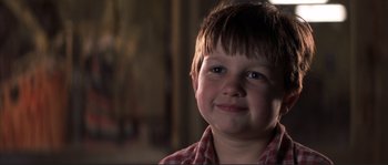 Movie still from “The Rookie” (2002), directed by John Lee Hancock – A young boy is smiling for the camera; Close Up shot, Low angle