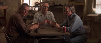 Movie still from “The Rookie” (2002), directed by John Lee Hancock – A group of men sitting at a table playing cards; Medium shot, High angle