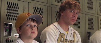 Movie still from “The Rookie” (2002), directed by John Lee Hancock – Two young baseball players sitting next to each other; Close Up shot, Low angle
