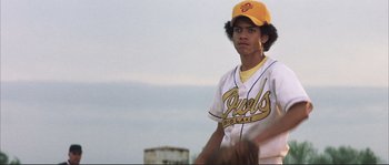 Movie still from “The Rookie” (2002), directed by John Lee Hancock – A young baseball player in a yellow cap and uniform; Close Up shot, Low angle