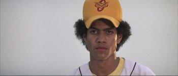 Movie still from “The Rookie” (2002), directed by John Lee Hancock – A man with a yellow hat and a white t - shirt; Close Up shot, Low angle