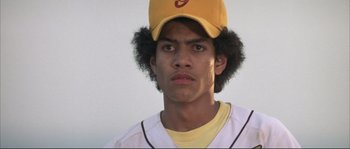 Movie still from “The Rookie” (2002), directed by John Lee Hancock – A young baseball player wearing a yellow hat; Close Up shot, Low angle