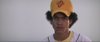 Movie still from “The Rookie” (2002), directed by John Lee Hancock – A young man wearing a baseball cap and a baseball uniform; Close Up shot, Low angle
