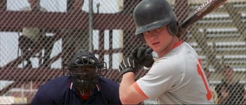 Movie still from “The Rookie” (2002), directed by John Lee Hancock – A baseball player is swinging at a pitch; Close Up shot, Over the shoulder angle