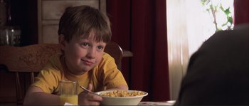 Movie still from “The Rookie” (2002), directed by John Lee Hancock – A boy sitting at a table with a bowl of cereal; Close Up shot, Low angle