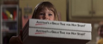 Movie still from “The Rookie” (2002), directed by John Lee Hancock – A little girl is peeking over the top of a stack of books; Extreme Close Up shot, Low angle
