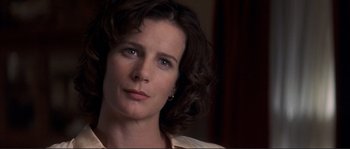 Movie still from “The Rookie” (2002), directed by John Lee Hancock – A woman's face in a dark room; Close Up shot, Low angle