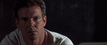 Movie still from “The Rookie” (2002), directed by John Lee Hancock – A person wearing a white t - shirt; Close Up shot, Low angle