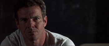 Movie still from “The Rookie” (2002), directed by John Lee Hancock – A person wearing a white t - shirt; Close Up shot, Low angle