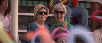 Movie still from “The Rookie” (2002), directed by John Lee Hancock – Two older women wearing sun hats and sunglasses; Medium shot, High angle